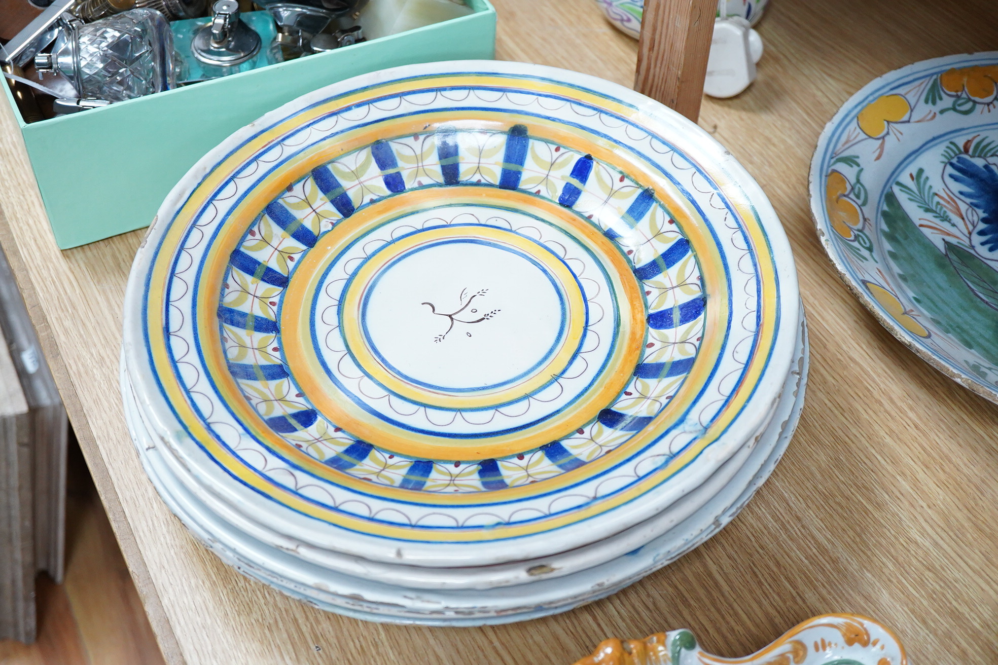 Two 18th century Delft polychrome chargers, five other faience chargers, a rectangular 19th century French faience dish and a blue and white letter rack